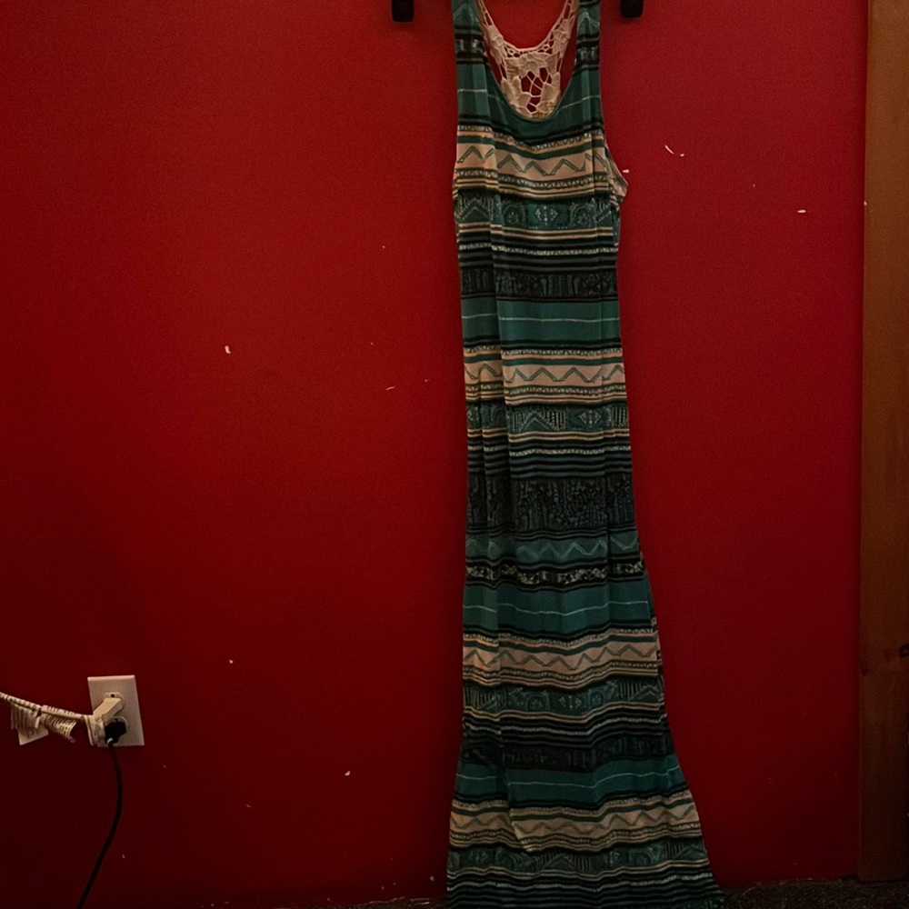 Long, maxi skirt style dress with blue/green base color and multi color details